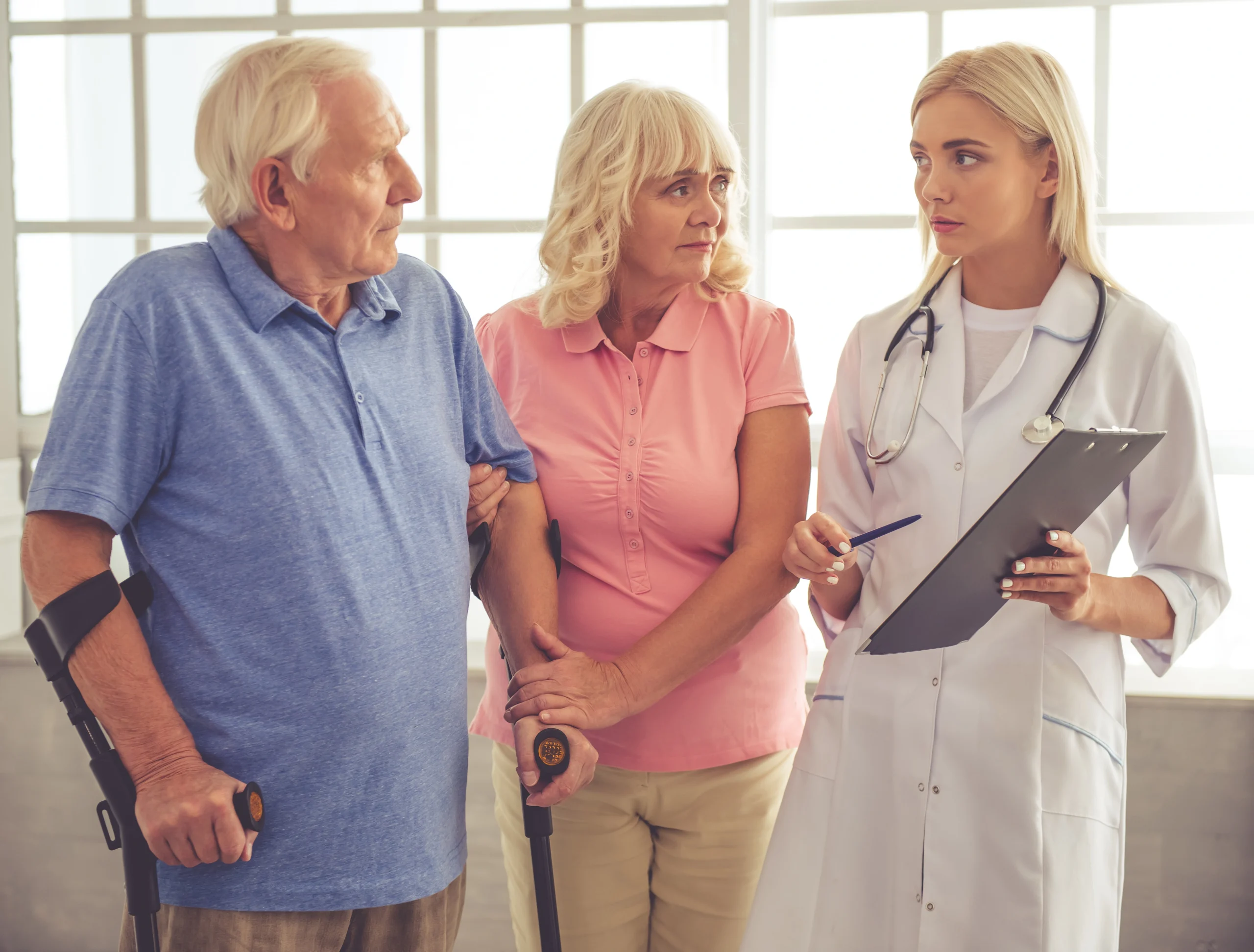 beautiful-young-female-doctor-is-talking-old-couple