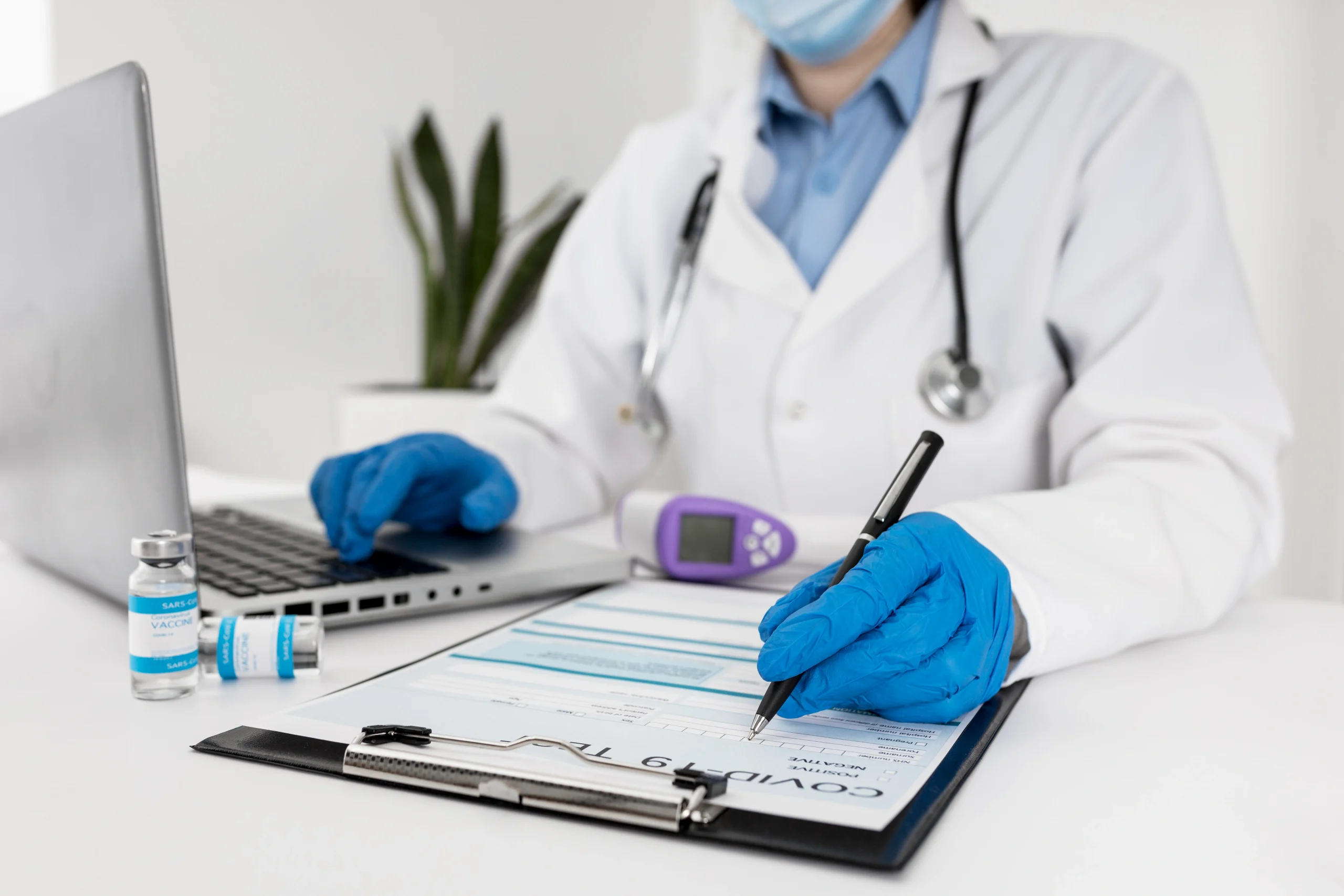close-up-doctor-working-laptop