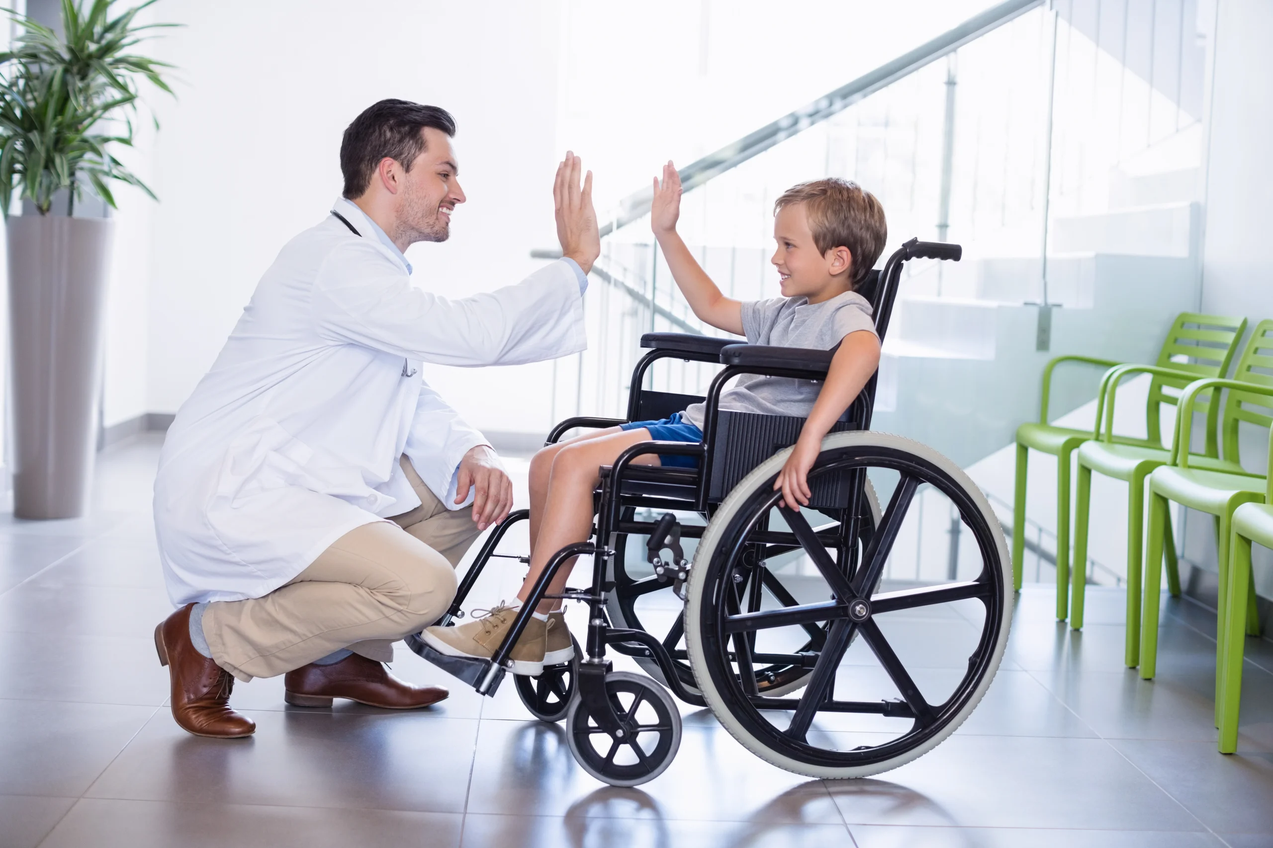 doctor-giving-high-five-disable-boy