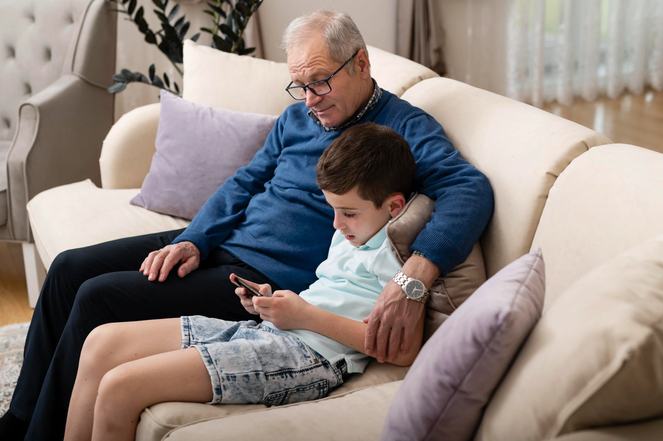grandchild-grandfather-relaxing-couch