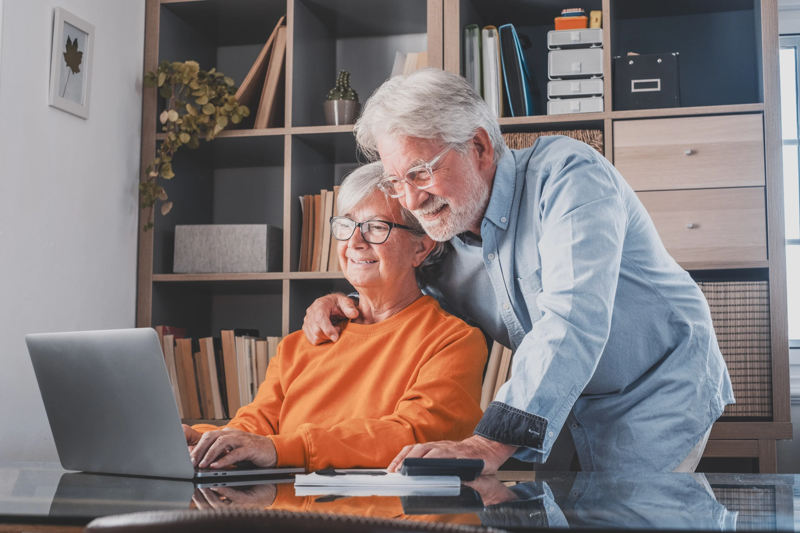 happy-elderly-60s-couple-sit-rest-couch-home-pay-household-expenses-online-computer