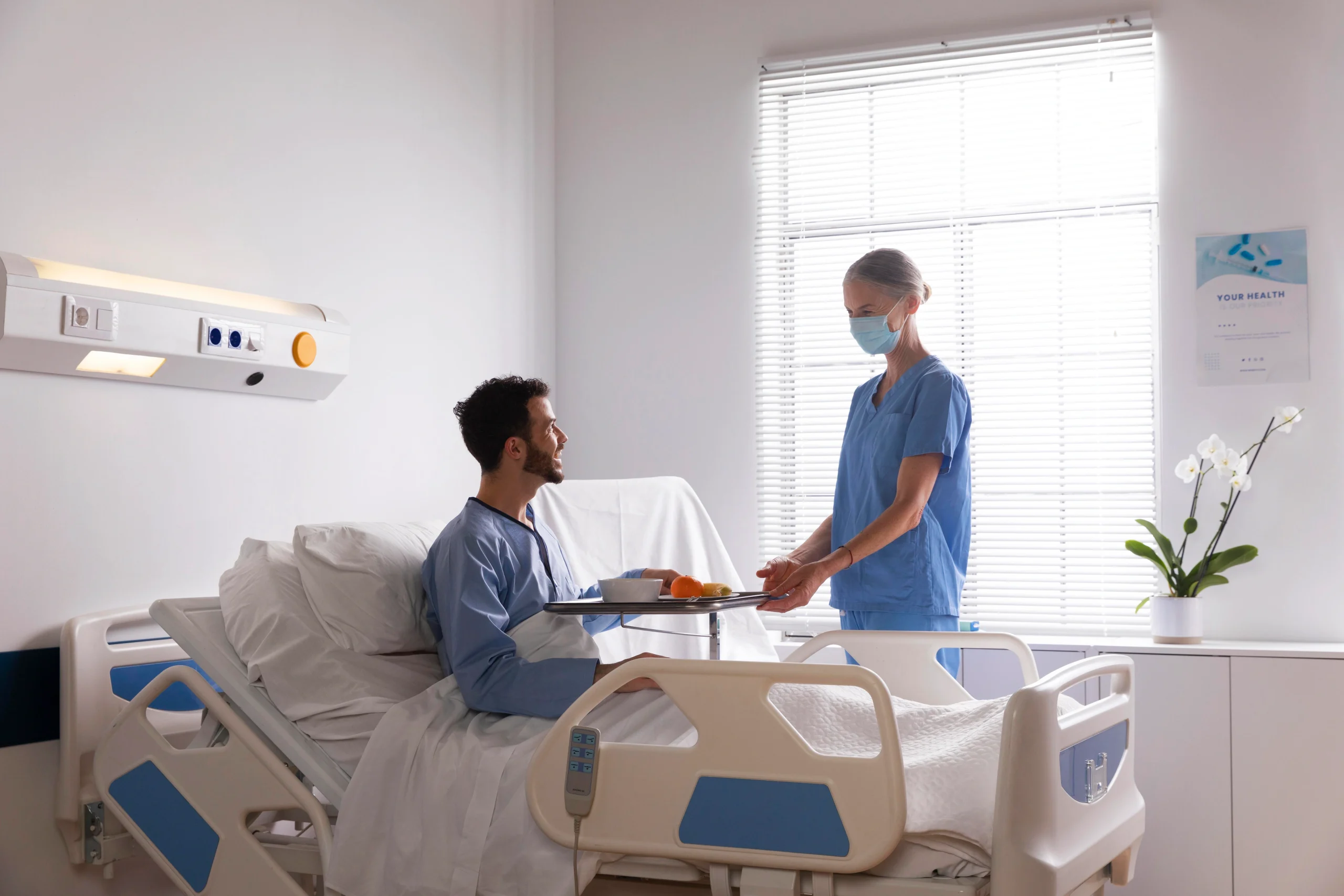 male-patient-bed-talking-nurse