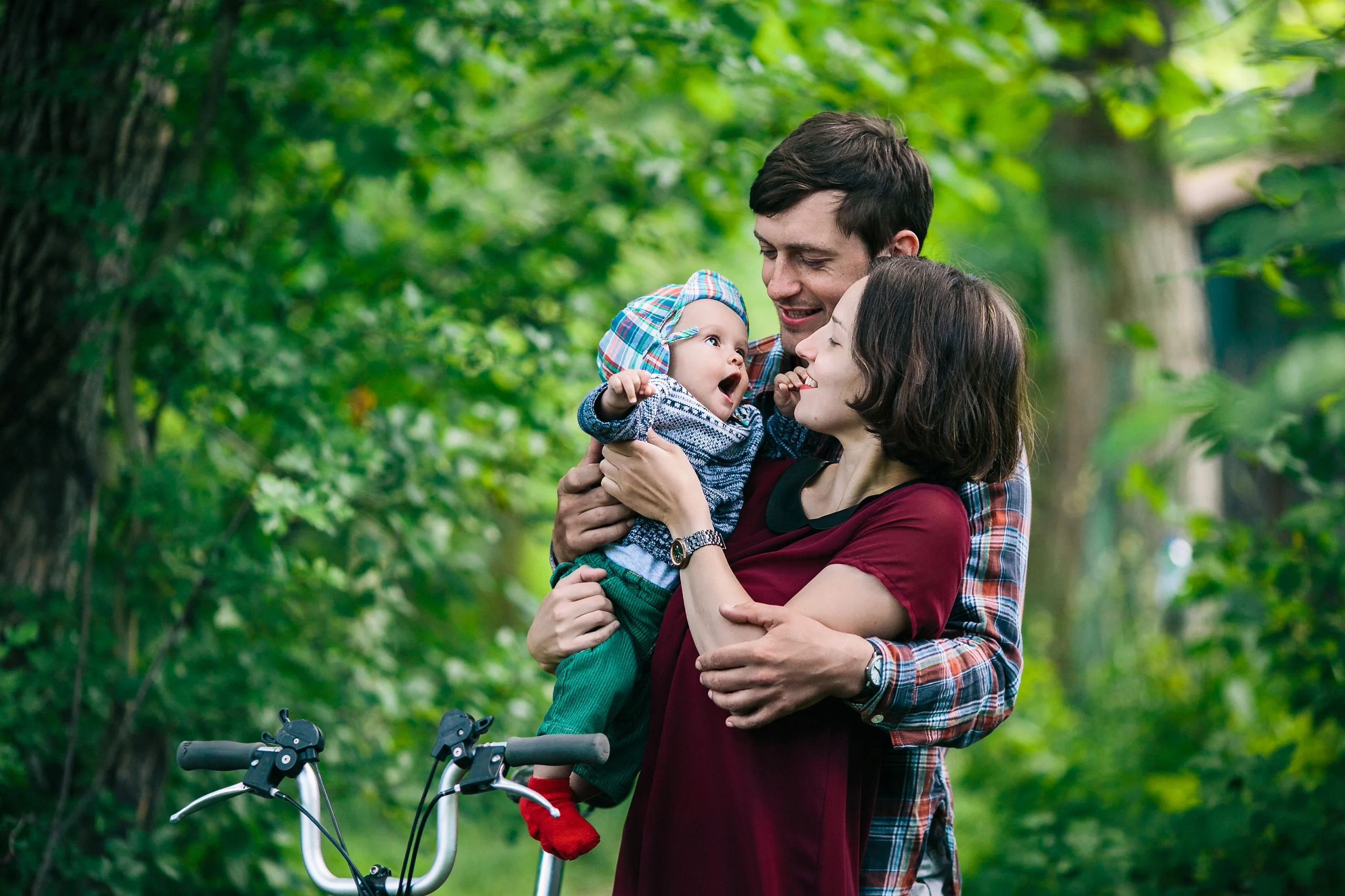 mother-father-holding-baby-outside