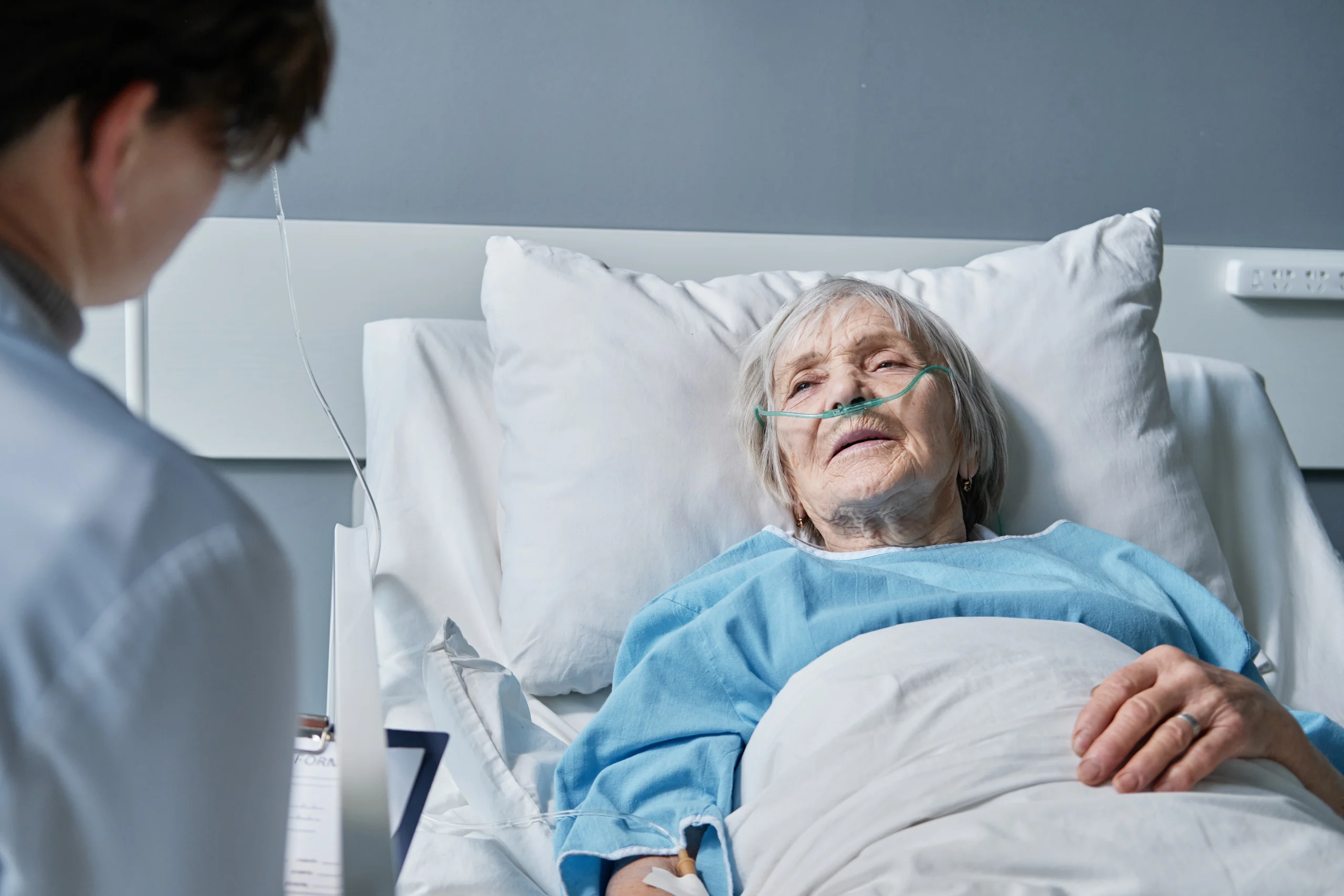senior-woman-listening-recommendations-her-doctor-while-she-lying-bed-hospital-ward